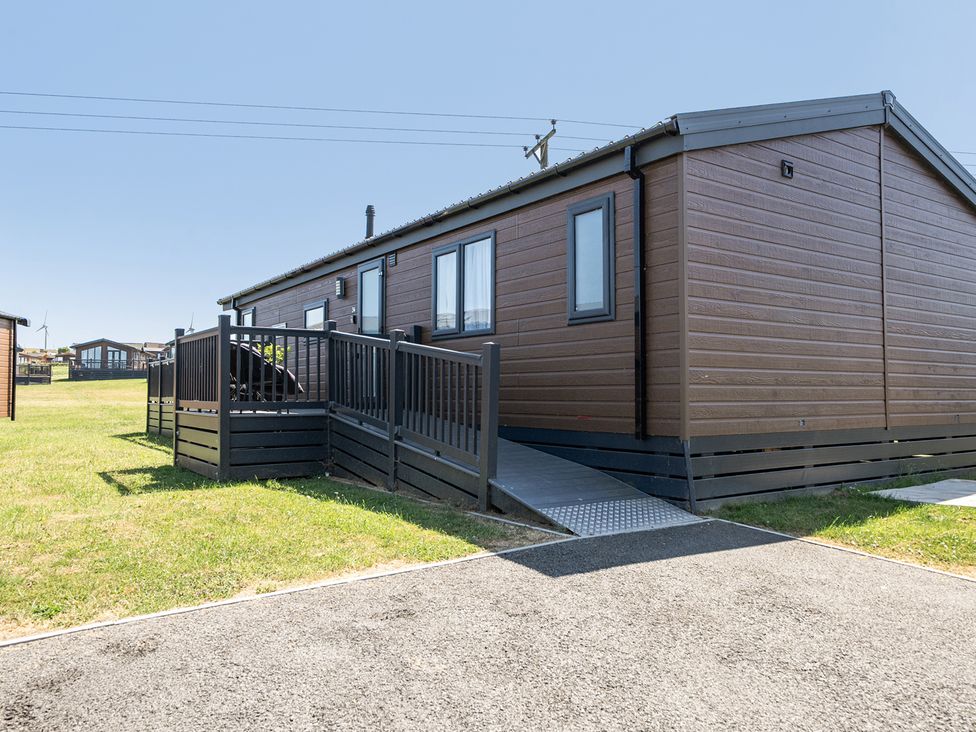 An outdoor view of a lodge with ramps at Atlantic Breeze Luxury Lodge sleep 6 Mullacott near Ilfracombe