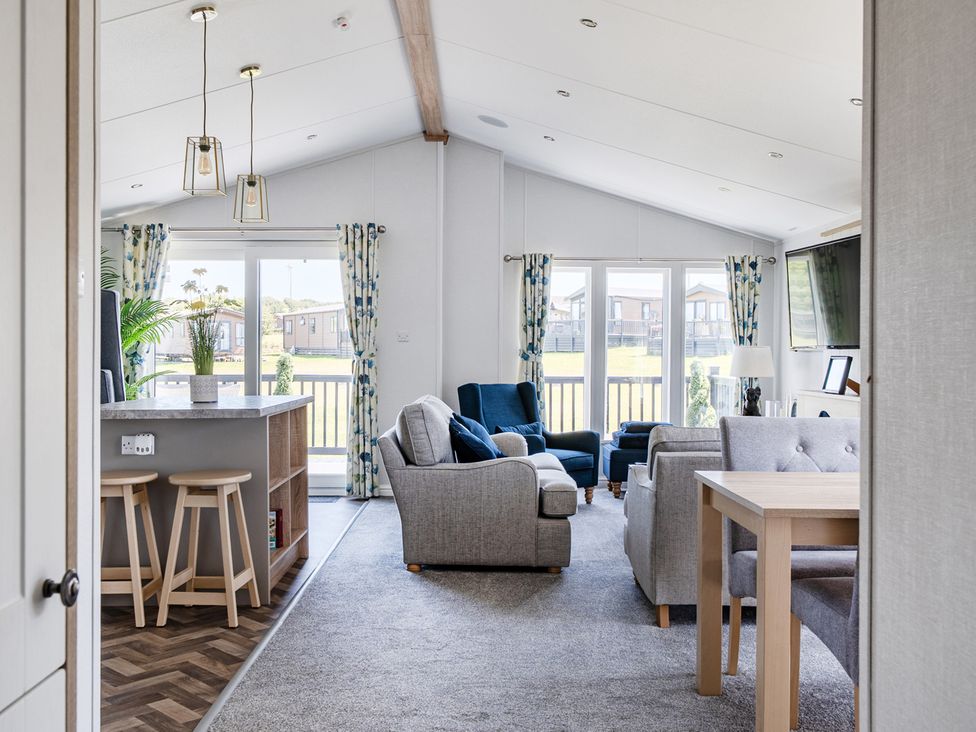 A living room with a sofa and table at Atlantic Breeze Luxury Lodge sleep 6 near Ilfracombe