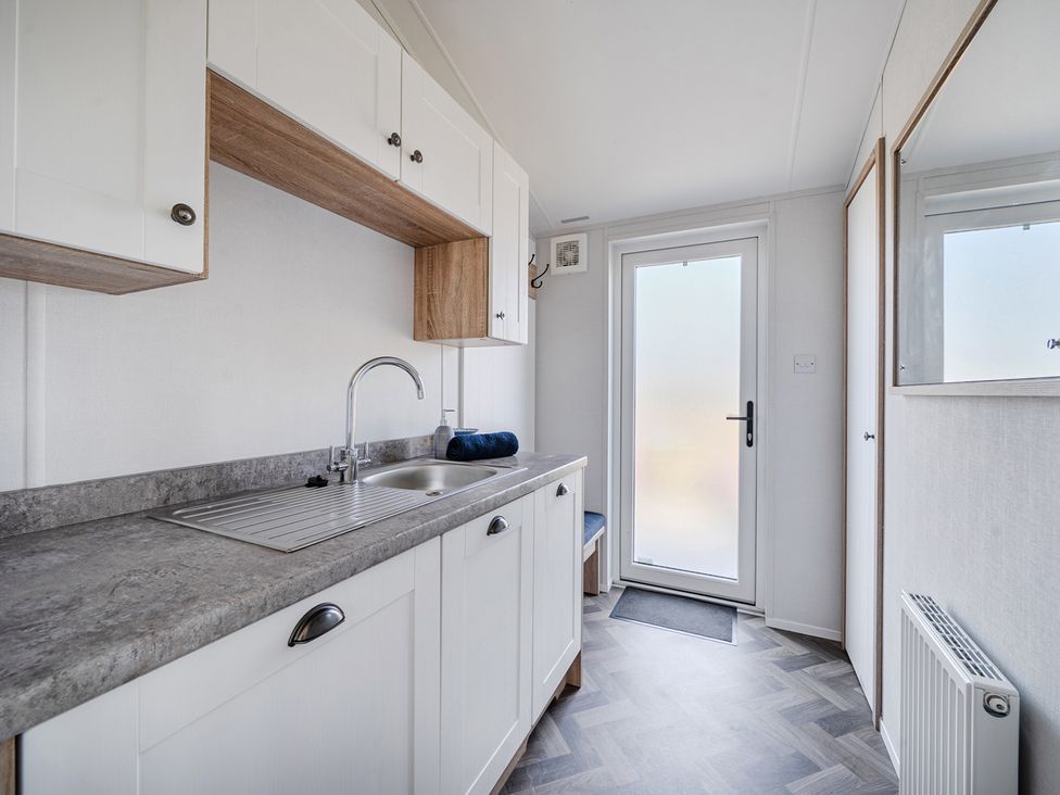 A kitchenette with sink and cabinets at Atlantic Breeze Luxury Lodge sleep 6 Mullacott near Ilfracombe