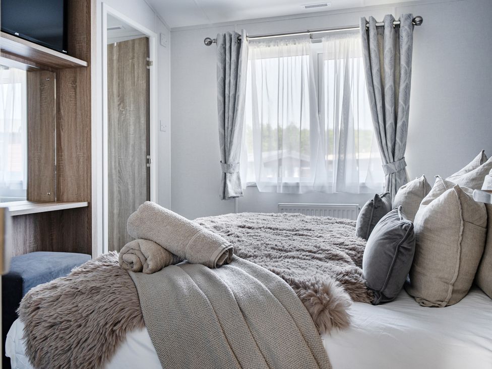 A bedroom with a bed and pillows at Atlantic Breeze Luxury Lodge sleep 6 Mullacott near Ilfracombe