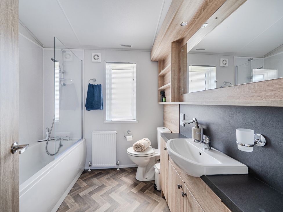 A bathroom with bathtub, shower, and sink at Atlantic Breeze Luxury Lodge sleep 6 Mullacott near Ilfracombe