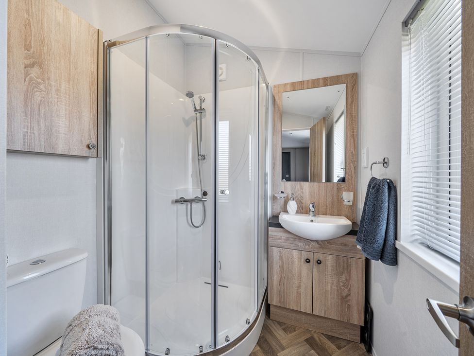 A bathroom with shower, sink, and toilet at Atlantic Breeze Luxury Lodge sleep 6 Mullacott near Ilfracombe