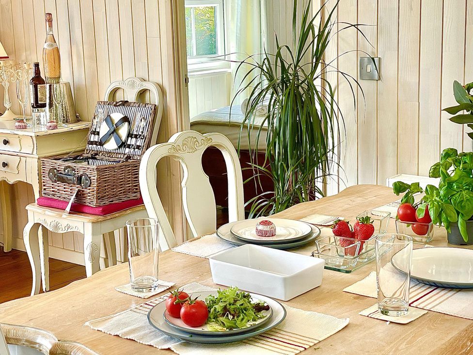 A dining room with a table set for a meal at Stunning Sleeps 6 Luxury Lodge Pets Mercia Marina near Willington, Derbyshire
