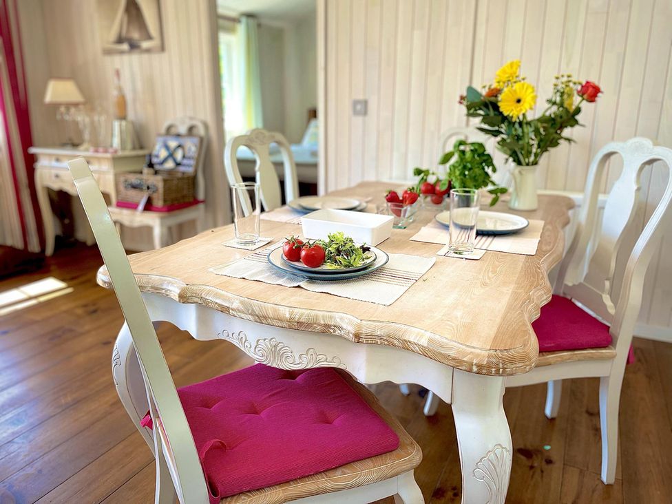 A dining room with a wooden table and chairs at Stunning Sleeps 6 Luxury Lodge Pets Mercia Marina near Willington, Derbyshire