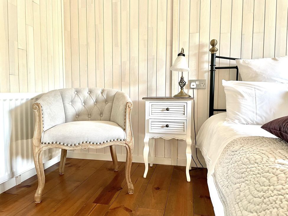 A bedroom with a bed and bedside table at Stunning Sleeps 6 Luxury Lodge Pets Mercia Marina near Willington, Derbyshire
