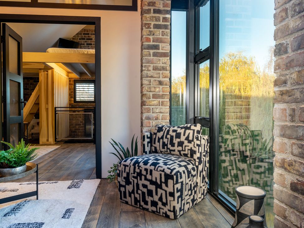 A snug area with an armchair and a staircase at the property in 