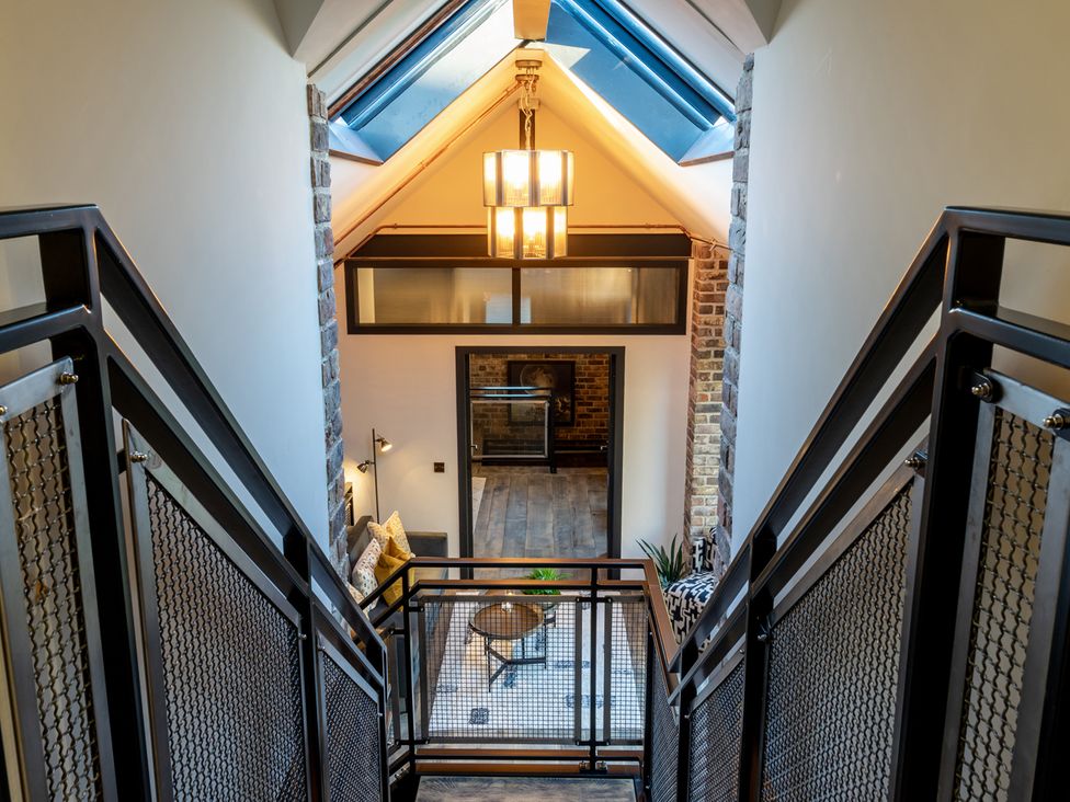A staircase with a table and sofa in a modern home