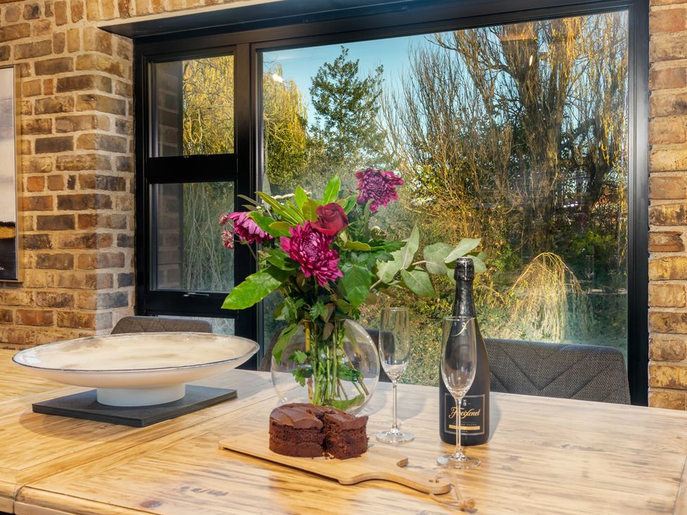 A dining room with flowers and chocolate cake at The Old Barn in Manchester
