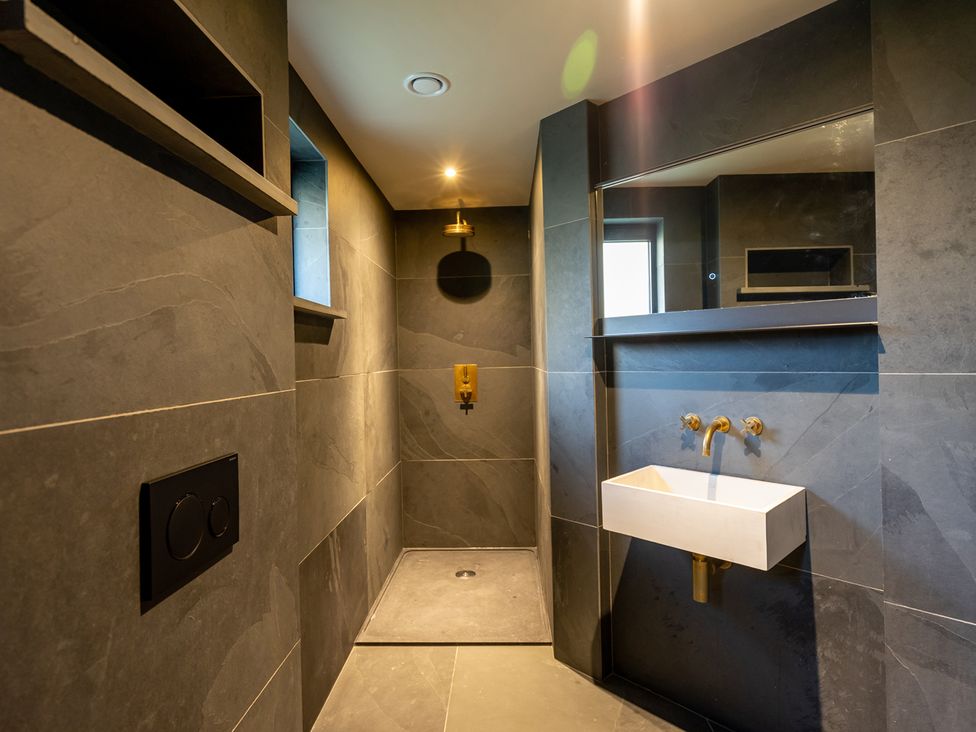 A bathroom with a shower and sink at the property