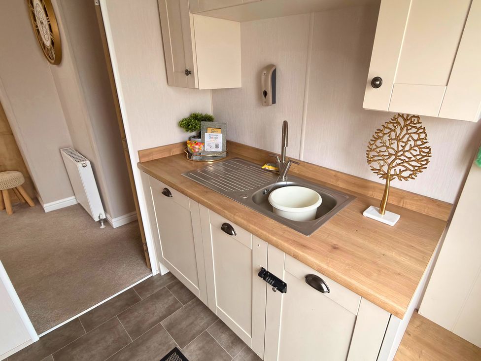 A kitchen with a sink and countertop at Meadows 33 Hot tub Southview Holiday Park Skegness