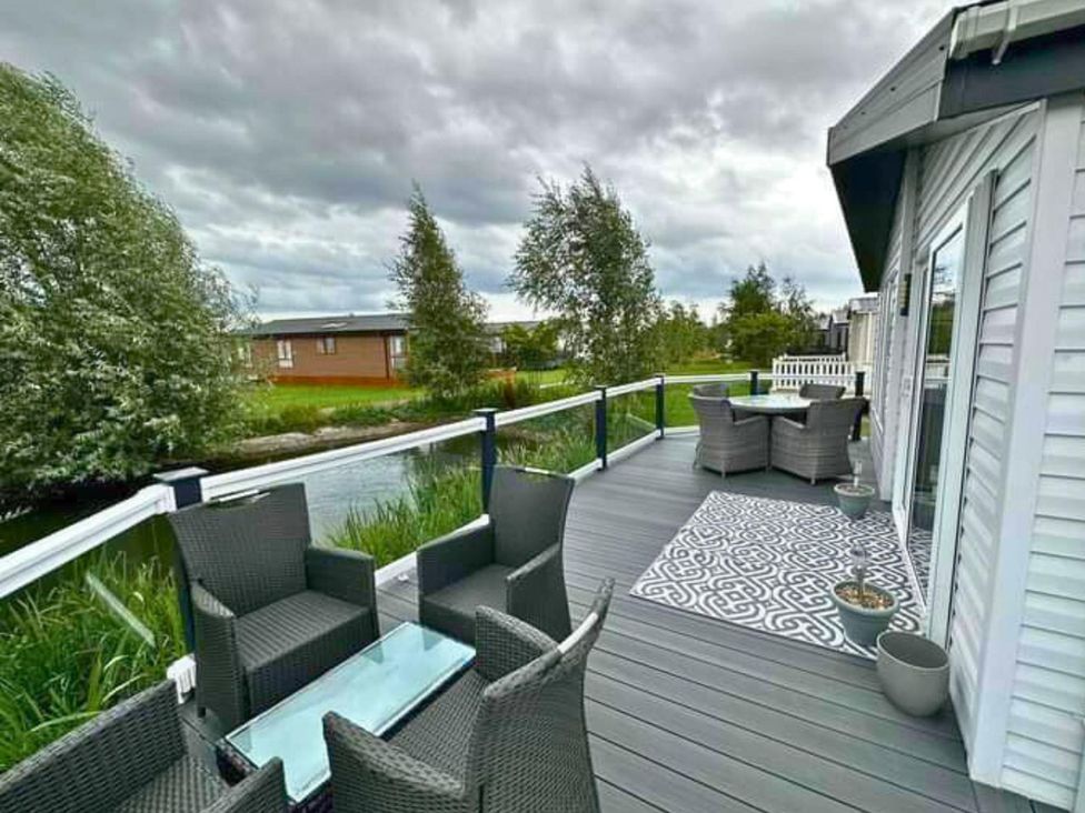 An outdoor seating area with chairs and a table at Sunset 19 Southview Holiday Park Skegness