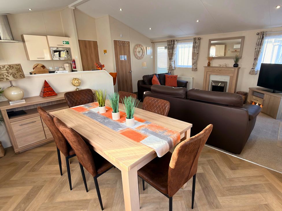 A dining area with a table and chairs at Sunset 19 Southview Holiday Park Skegness