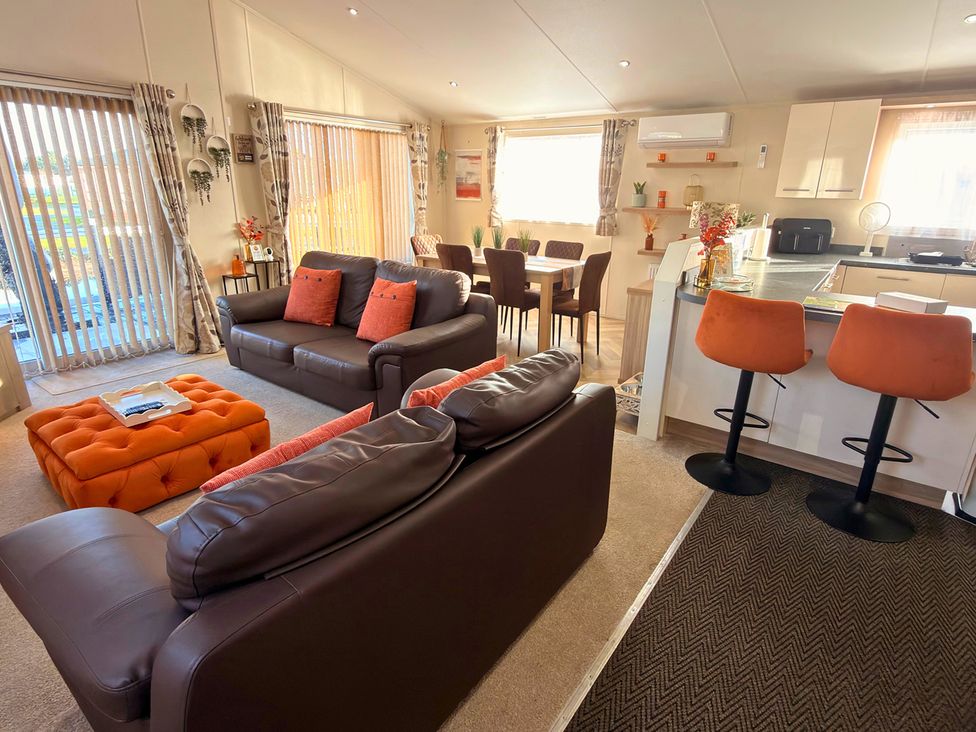 A living room with seating and a dining area at Sunset 19 Southview Holiday Park Skegness