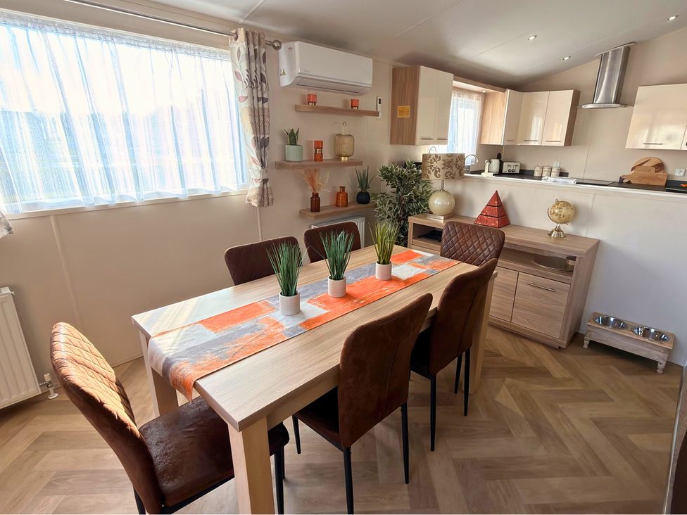 A dining room with a table and chairs at Sunset 19 Southview Holiday Park Skegness