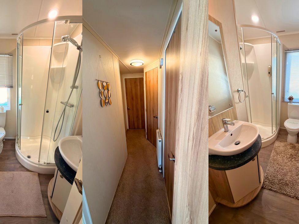 A bathroom with a shower, sink, and toilet at Sunset 19 Southview Holiday Park Skegness