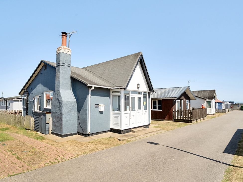 A house with a chimney and mailbox at Seahorse Chalet Sleeps 6 Pets Log Burner Beach in Bridlington