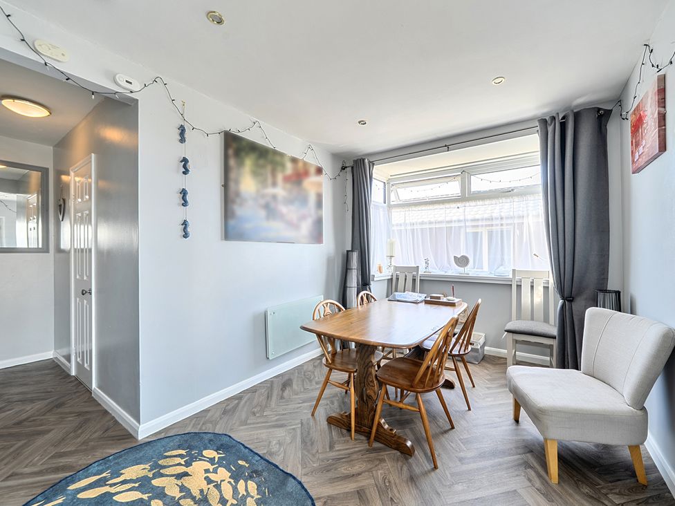 A dining room with a table and chairs at Seahorse Chalet Sleeps 6 Pets Log Burner Beach in Bridlington