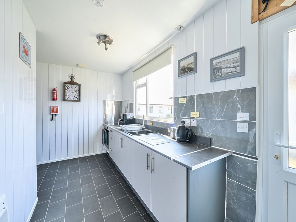 A kitchen with a sink and kettle at Seahorse Chalet Sleeps 6 Pets Log Burner Beach in Bridlington