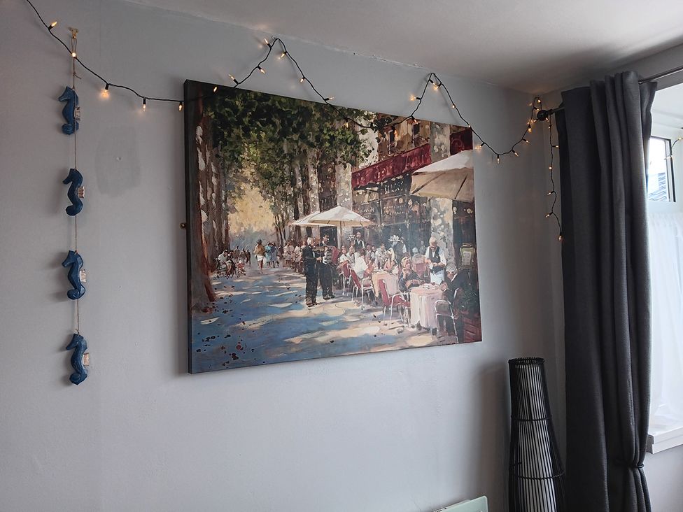 A living room with a painting on the wall at Seahorse Chalet Sleeps 6 Pets Log Burner Beach in Bridlington