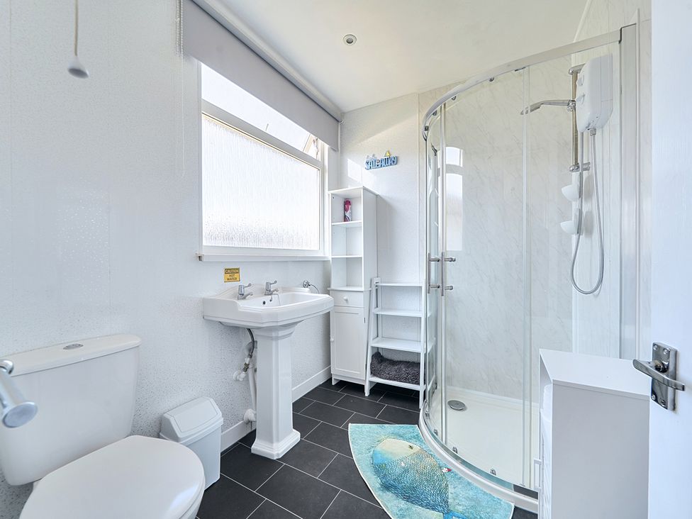 A bathroom with a shower, sink, and toilet at Seahorse Chalet Sleeps 6 Pets Log Burner Beach in Bridlington