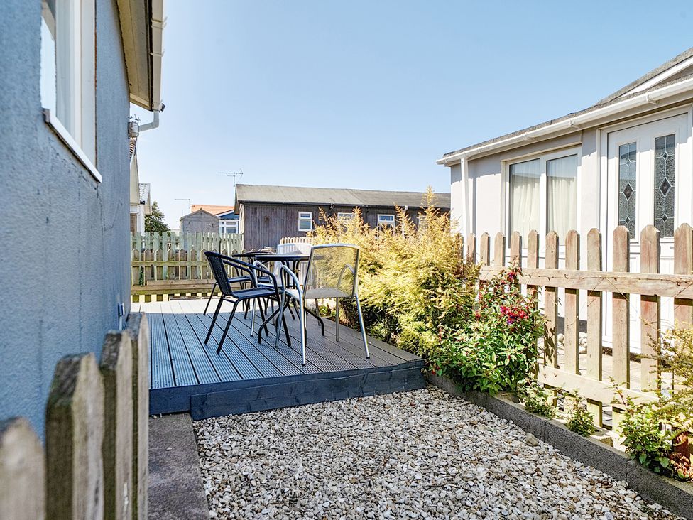 An outdoor area with a table and chairs at Seahorse Chalet Sleeps 6 Pets Log Burner Beach Bridlington