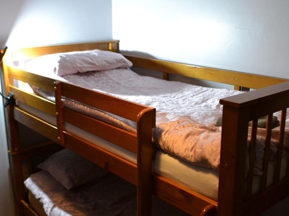 A bunk bed with mattresses and pillows at Sea Side Stay 6 Pet Friendly Parking Garden Rhosneigr