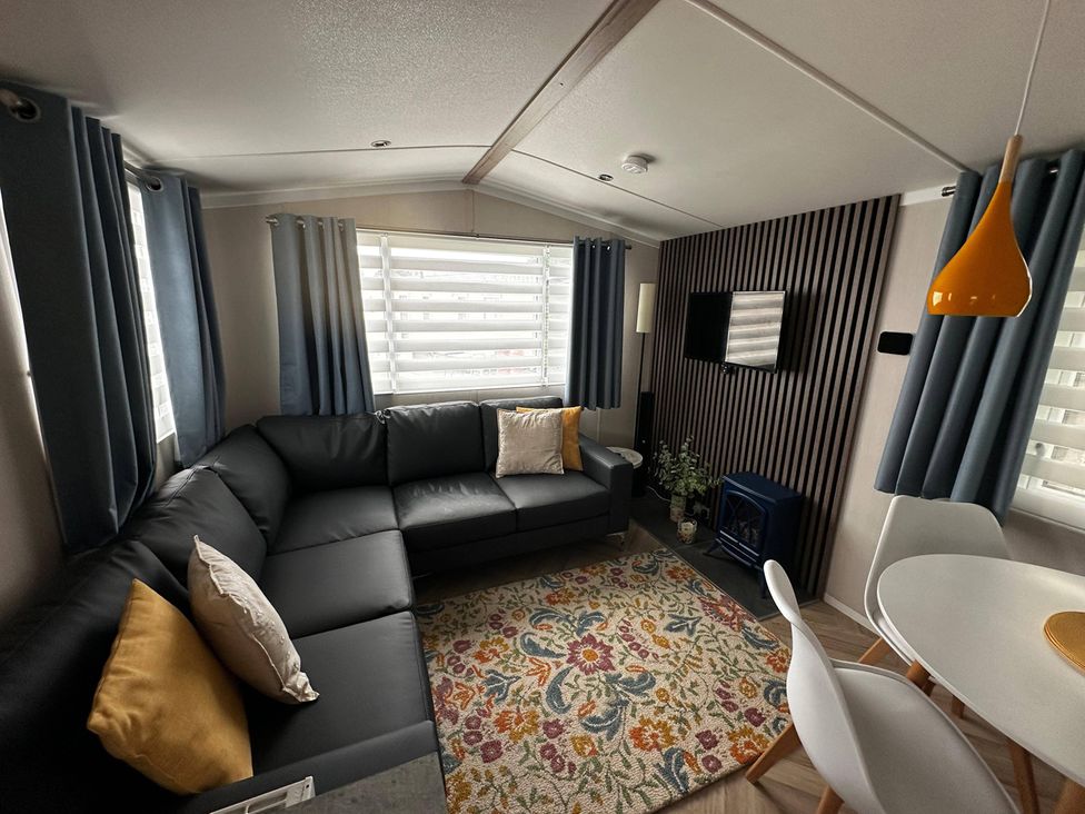 A living room with a sofa and dining table at The Old Barn in Manchester