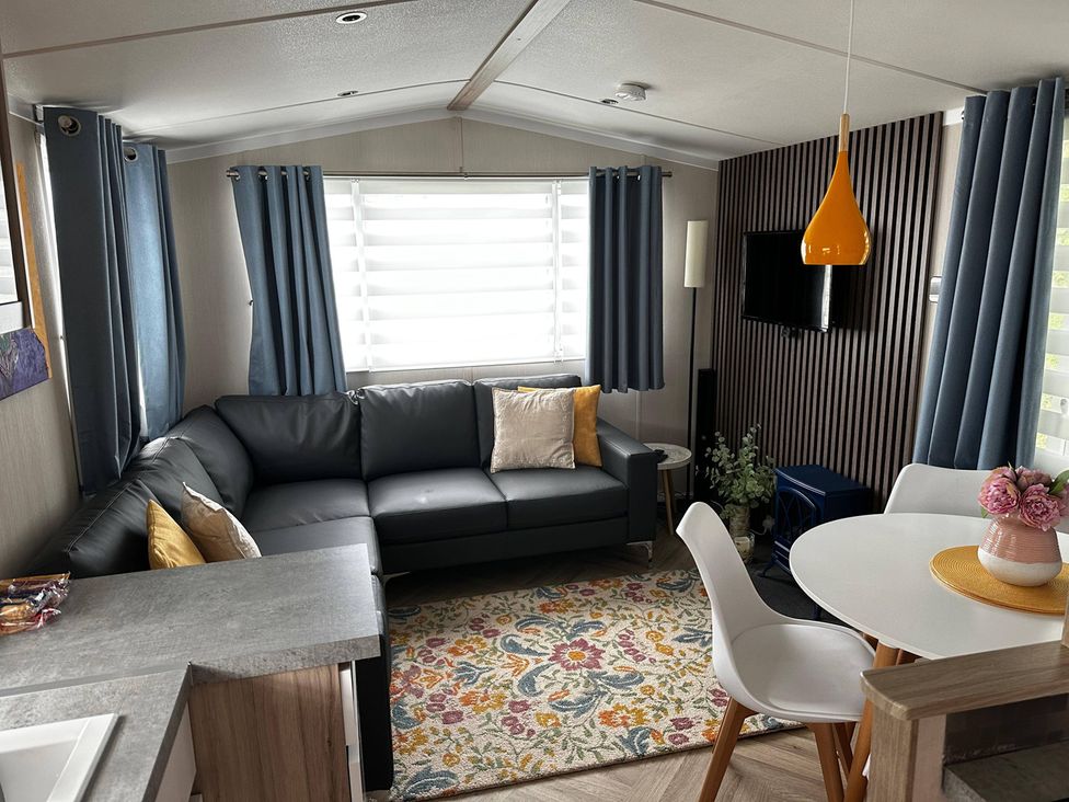 A living room with a sofa and dining table at the property