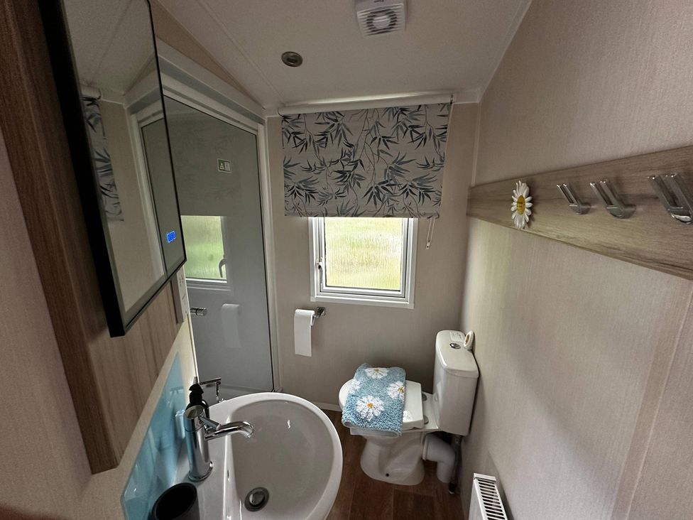 A bathroom with a sink, toilet, and shower at 