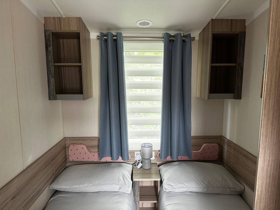 A bedroom with two beds and storage cabinets at 