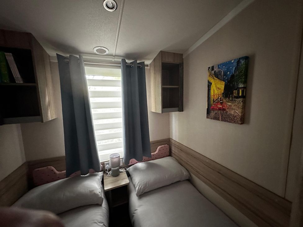 A bedroom with two beds and shelves at the property in unknown location