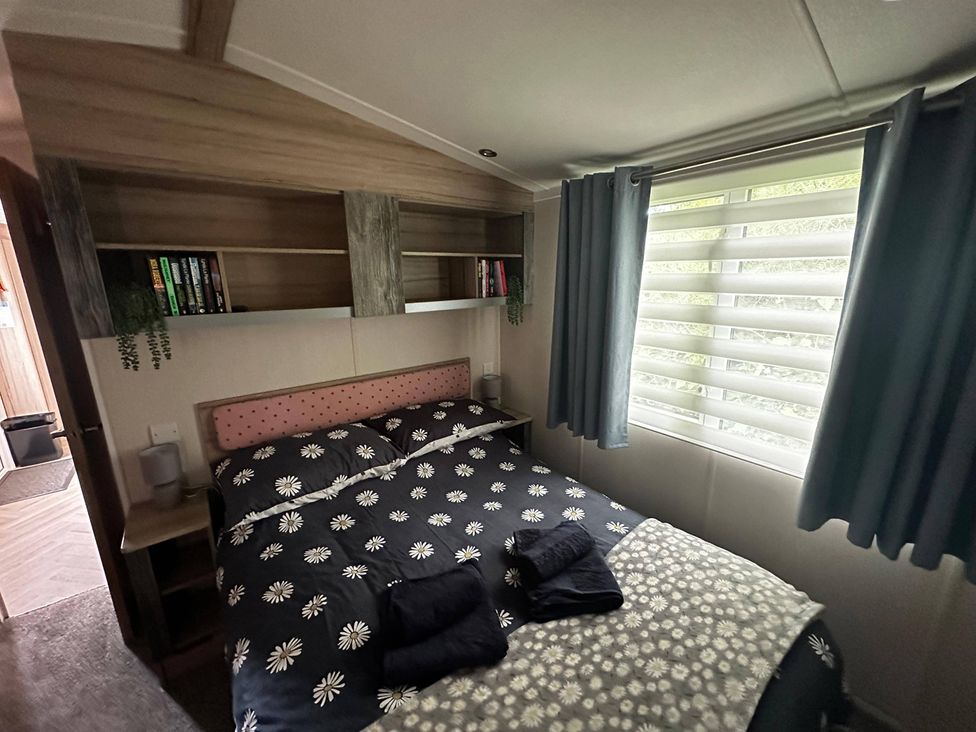 A bedroom with a bed and shelves at the property name in the location