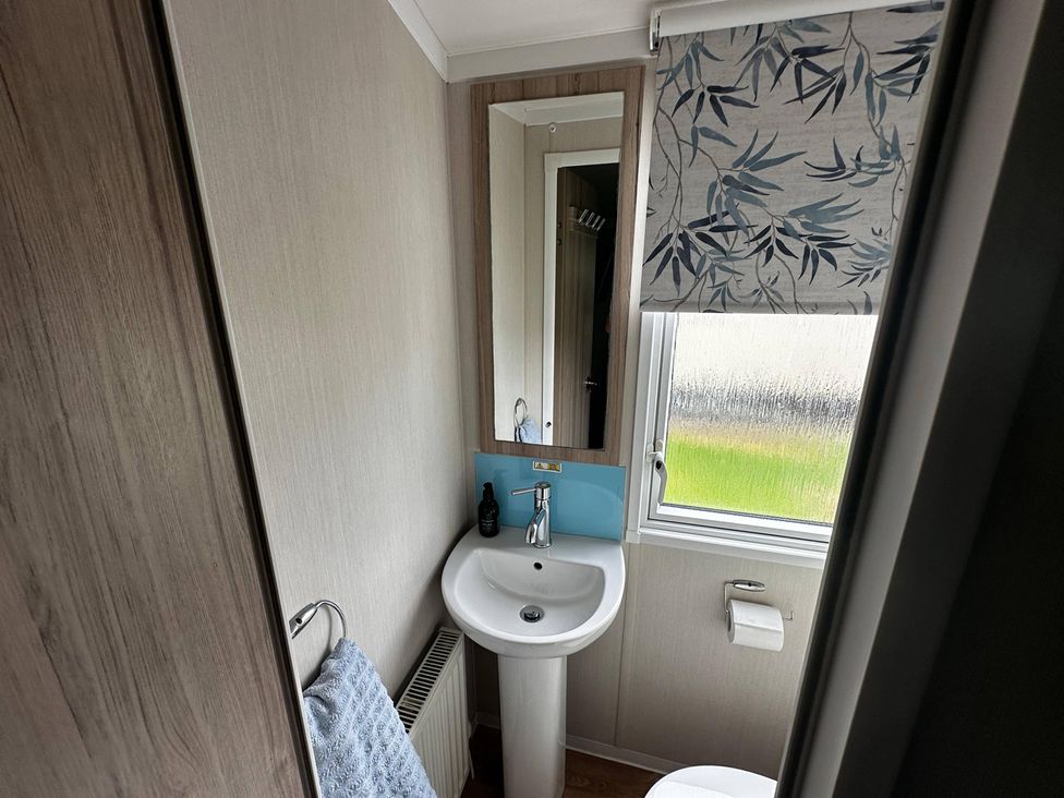 A bathroom with a sink and mirror at the property