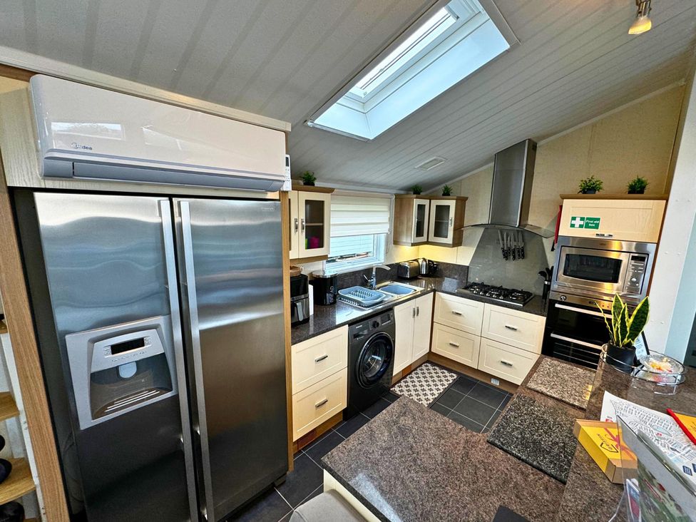 A kitchen with appliances and cabinets at Sunset 5 Southview Holiday Park Skegness