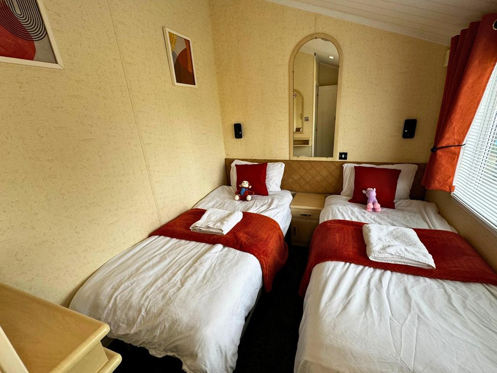 A bedroom with two single beds at Sunset 5 Southview Holiday Park Skegness