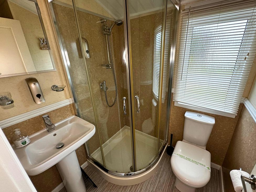 A bathroom with a shower, sink and toilet at Sunset 5 Southview Holiday Park Skegness