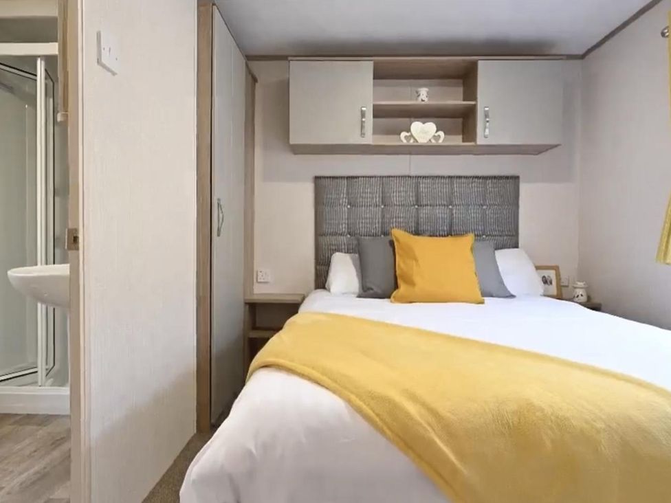 A bedroom with a bed and shelf at The Old Barn in Manchester