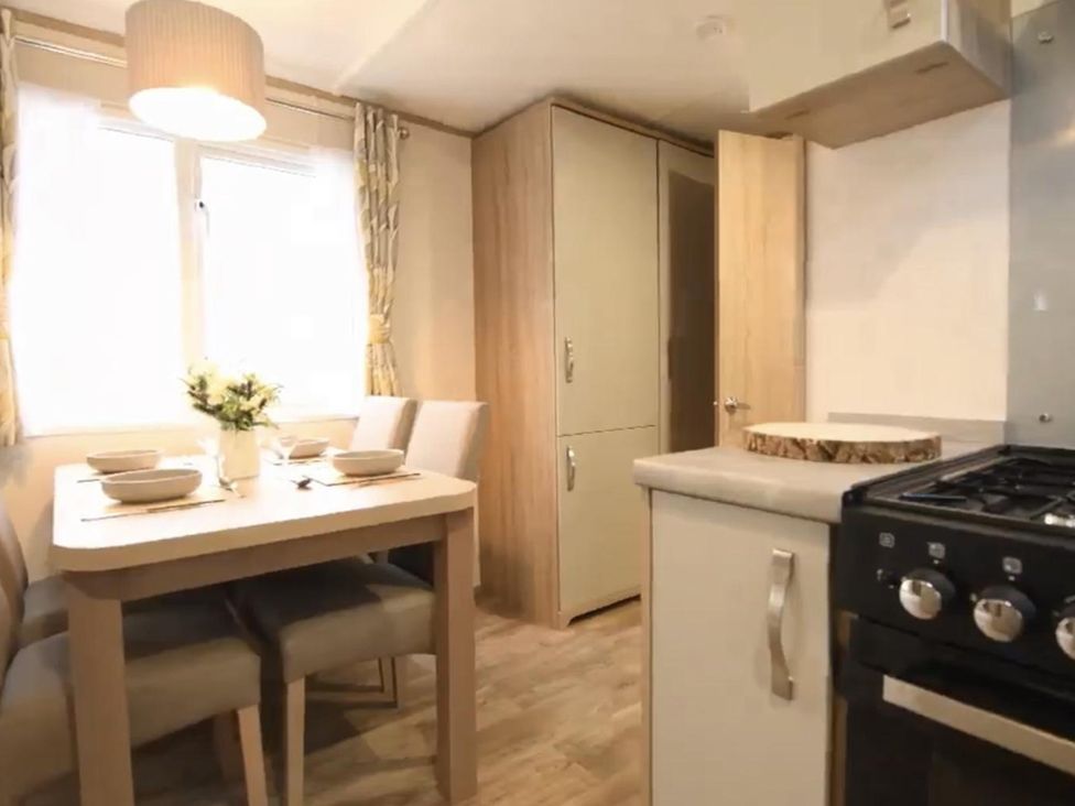 A dining area with a table and chairs at the property in location