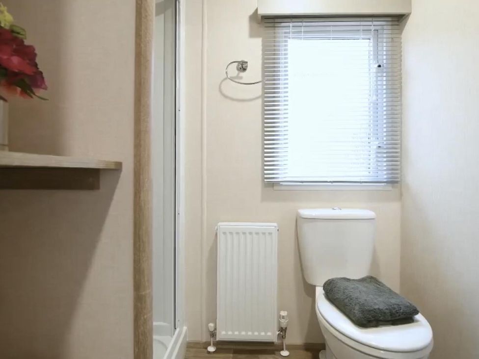 A bathroom with a shower and toilet at 