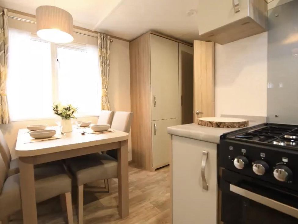 A kitchen with table and chairs at the property
