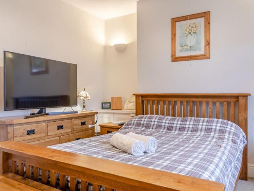 A bedroom with a bed and television at The Old Barn in Manchester
