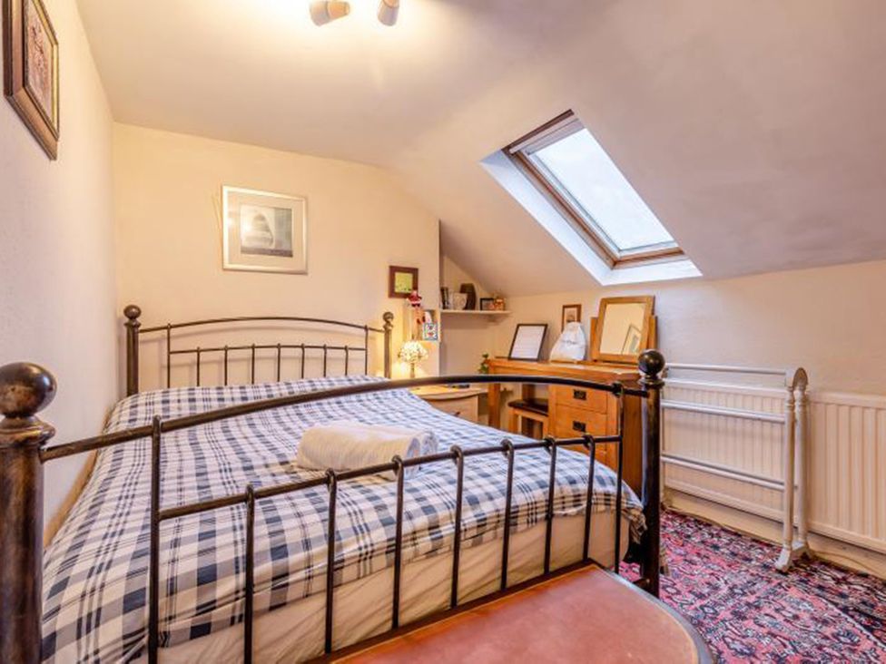 A bedroom with a bed and desk at  in 