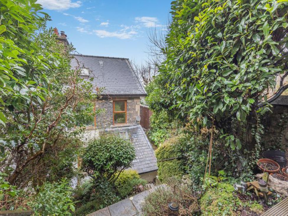 A garden view with a house surrounded by greenery at The Garden House in unknown location