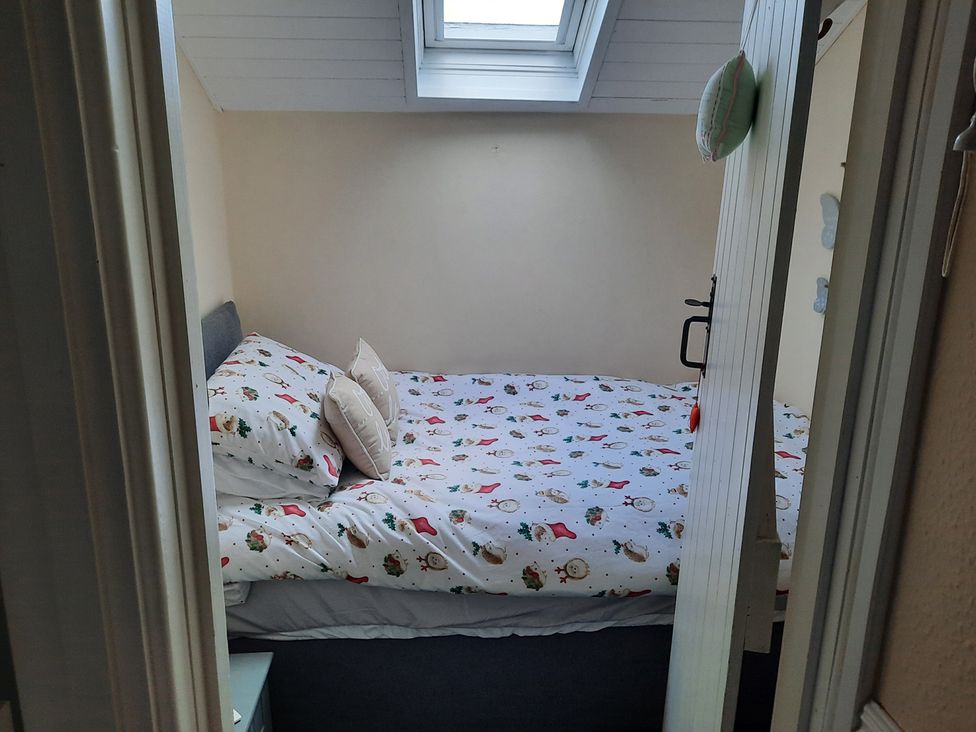 A bedroom with a bed and window at The Old Barn in Manchester