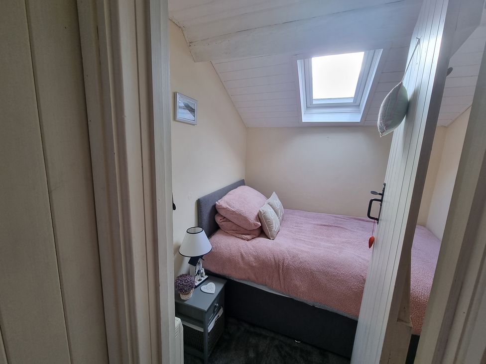 A bedroom with a bed and nightstand at The Old Barn in Manchester