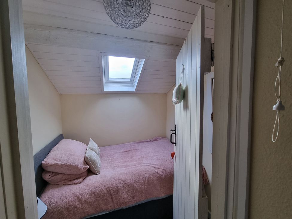 A bedroom with a bed and window at a property