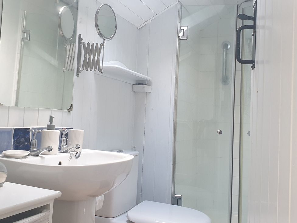 A bathroom with a sink, toilet, and shower at The Old Barn in Manchester