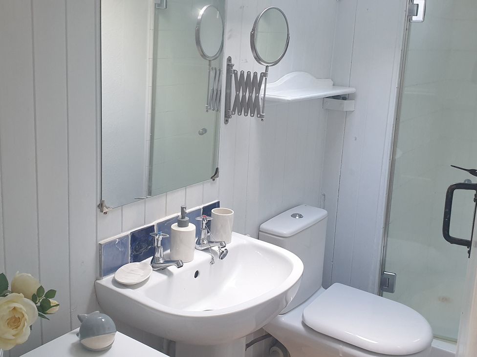 A bathroom with a sink, toilet and shower at The Old Barn in Manchester