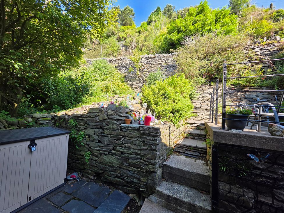 A garden with stone walls, steps, and plants at a residential area