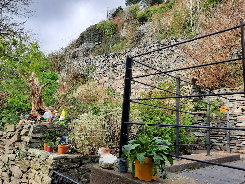 A garden with stone wall and plants at the property